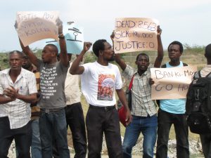 Demonstrators calling upon the UN and the Haitian government to respond to the epidemic