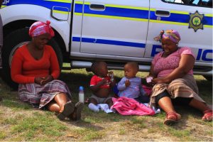 Khayelitsha residents take a break outside the Commission’s public hearings, picture: Shae Herrmann