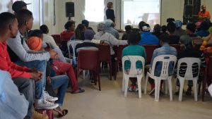 Youth leader Mnikelo Ndabankulu presents on "The Art of Organizing" in Khayelitsha informal settlement, Cape Town, during the South Africa screening tour, May 2015. Photo credit: Sleeping Giant