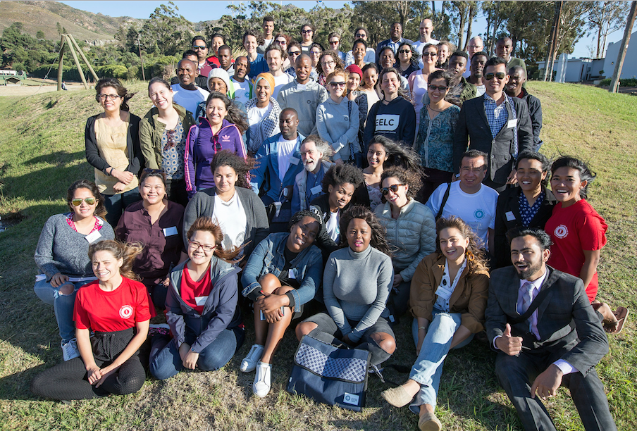 A diverse group of young lawyers pose for a picture